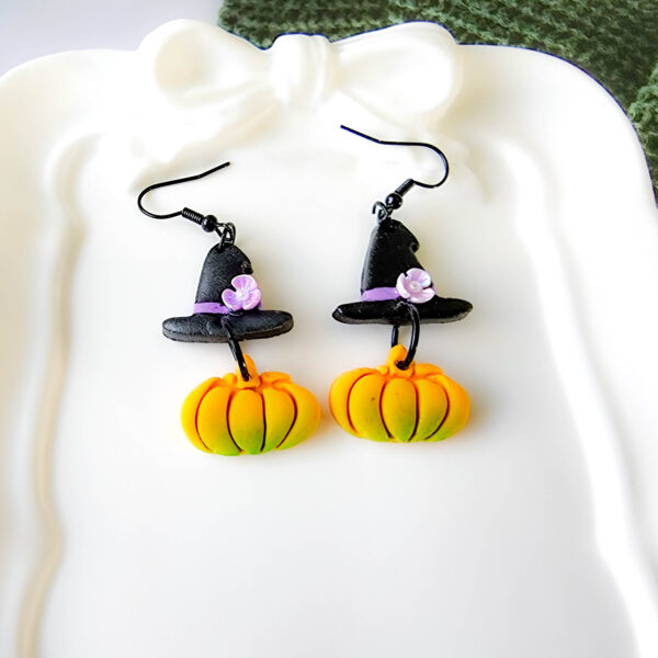 Orellie's handmade witch hat and pumpkin earrings, New Zealand-made and available in different colors. Choose your favorite spooky design for the perfect Halloween accessory.