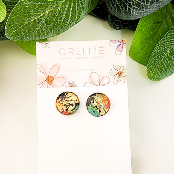 Add a touch of elegance to your look with these Golden Earth stud earrings. Handcrafted by Orellie, featuring vibrant colors with a gold foil effect.