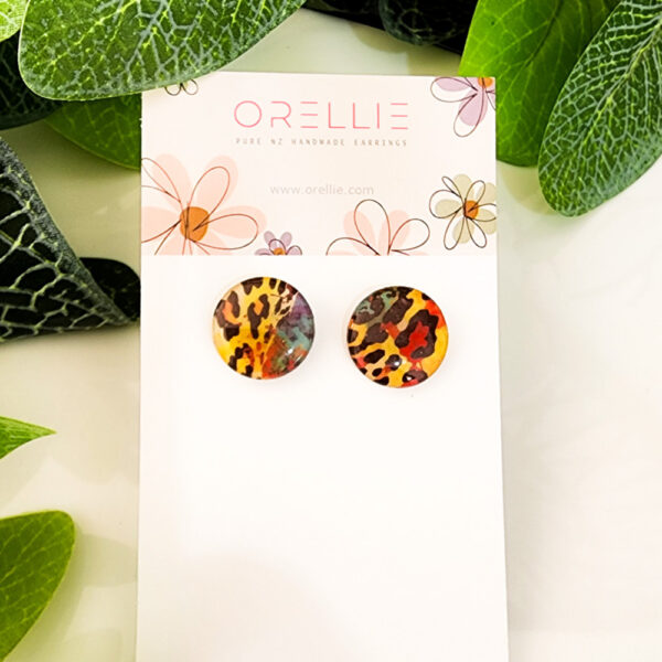 Make a bold statement with these Wild Leopard stud earrings. Handcrafted by Orellie, featuring a vibrant leopard print pattern with striking colors.