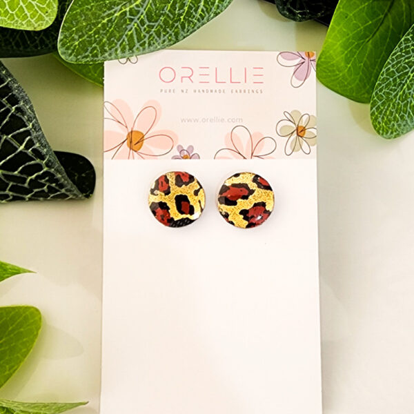 Make a bold statement with these Golden Leopard stud earrings. Handcrafted by Orellie, showcasing a striking leopard print with gold accents.