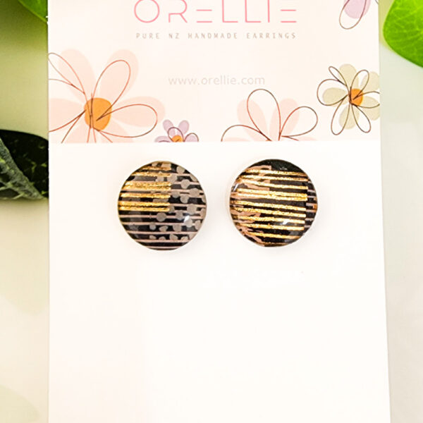 Add a touch of luxury to your style with these Golden Striped stud earrings. Handcrafted by Orellie, featuring elegant golden stripes on a neutral background.