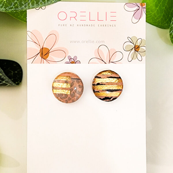 Add a touch of luxury to your style with these Golden Stripe Safari stud earrings. Handcrafted by Orellie, showcasing a blend of animal print and shimmering golden accents.