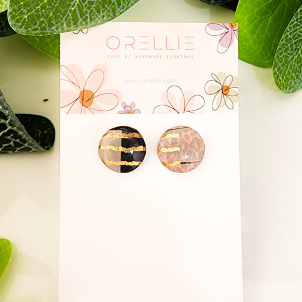 Add a touch of luxury to your style with these Golden Stripe Safari stud earrings. Handcrafted by Orellie, showcasing a blend of animal print and shimmering golden accents.