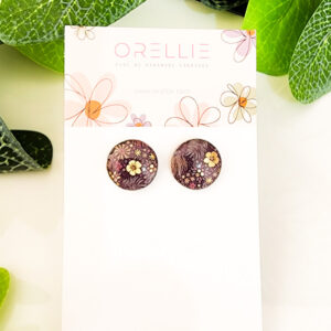 Elevate your look with these elegant golden flower stud earrings. Handcrafted by Orellie, they feature intricate floral details and gold accents