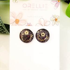 Embrace the beauty of dark elegance with these Midnight Blossom stud earrings. Handcrafted by Orellie, featuring intricate floral designs with gold accents.