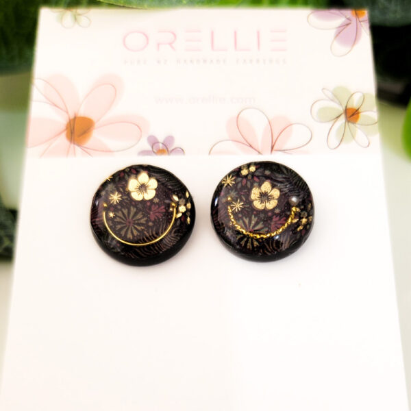 Embrace the beauty of dark elegance with these Midnight Blossom stud earrings. Handcrafted by Orellie, featuring intricate floral designs with gold accents.