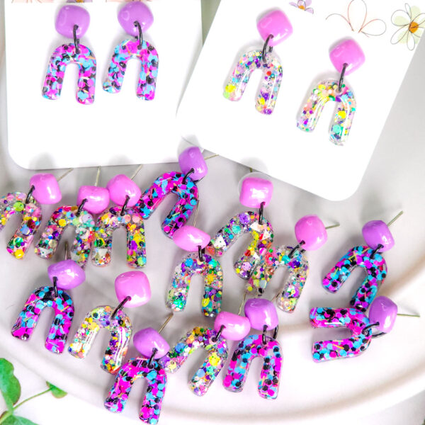 Brighten up your day with Orellie's handmade confetti arch earrings, designed and made in New Zealand. A perfect pop of color for any outfit.