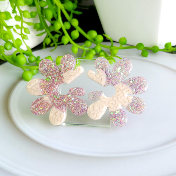 Embrace whimsical charm with the Fairy Glow Flowers collection from Orellie. These unique floral-inspired earrings add a playful sparkle to any look, perfect for fun occasions or a bold daily style.