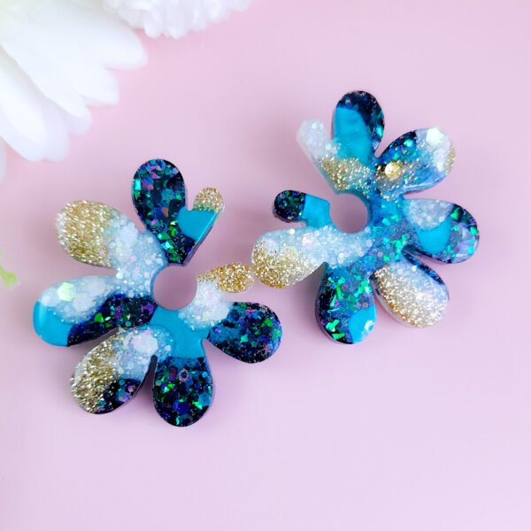 Embrace whimsical charm with the Fairy Glow Flowers collection from Orellie. These unique floral-inspired earrings add a playful sparkle to any look, perfect for fun occasions or a bold daily style.