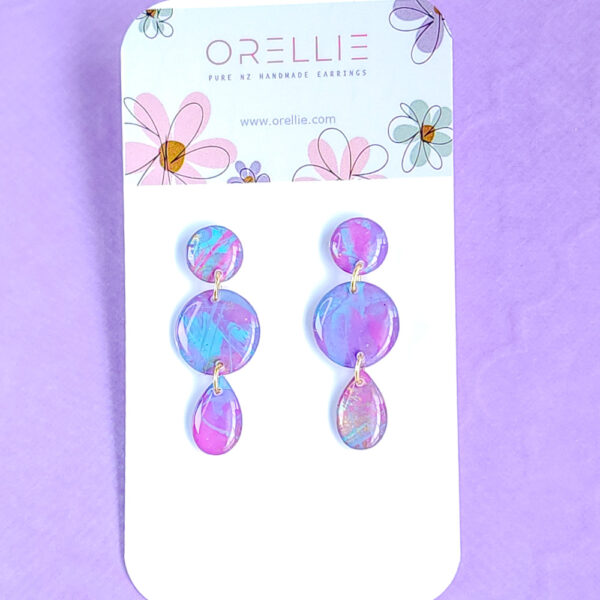 Brighten up your look with the hand-painted Pixie Pop Triple Drop earrings. These vibrant, colorful drops add playful charm to any outfit, perfect for standing out in style.