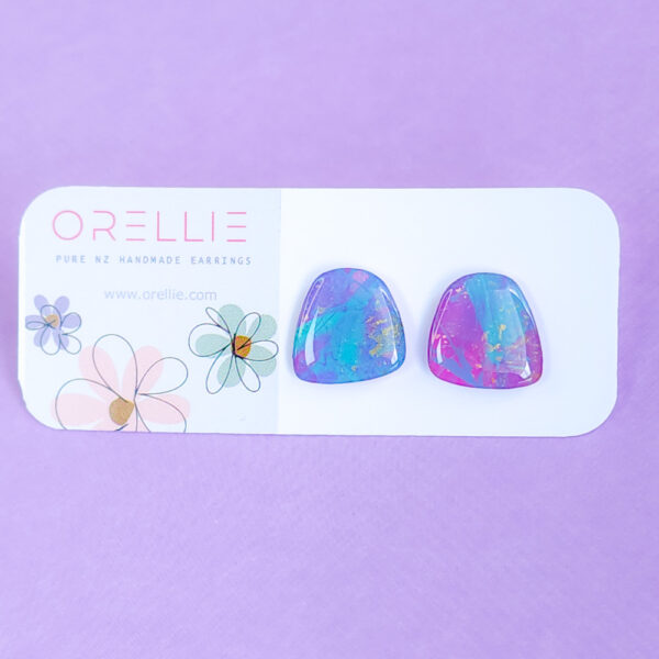 Brighten up your style with the Pixie Glint earrings from Orellie. These hand-painted, vibrant stud earrings are perfect for adding a unique and colorful touch to any outfit.