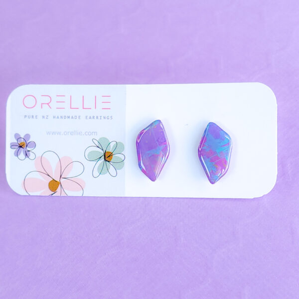 Add a pop of color with Pixie Drift earrings by Orellie. These hand-painted, diamond-shaped stud earrings bring a whimsical sparkle to your everyday or special occasion look.