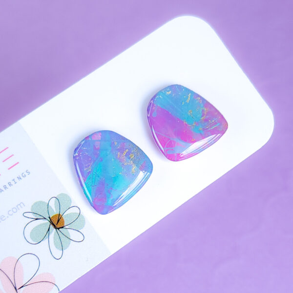 Brighten up your style with the Pixie Glint earrings from Orellie. These hand-painted, vibrant stud earrings are perfect for adding a unique and colorful touch to any outfit.