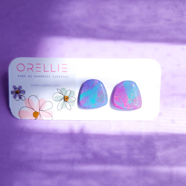 Brighten up your style with the Pixie Glint earrings from Orellie. These hand-painted, vibrant stud earrings are perfect for adding a unique and colorful touch to any outfit.