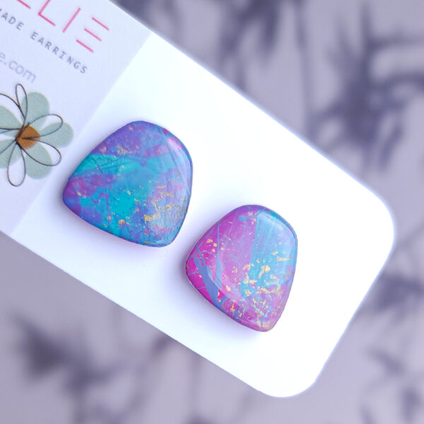 Brighten up your style with the Pixie Glint earrings from Orellie. These hand-painted, vibrant stud earrings are perfect for adding a unique and colorful touch to any outfit.