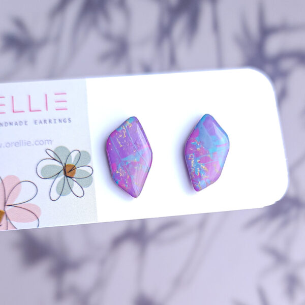 Add a pop of color with Pixie Drift earrings by Orellie. These hand-painted, diamond-shaped stud earrings bring a whimsical sparkle to your everyday or special occasion look.