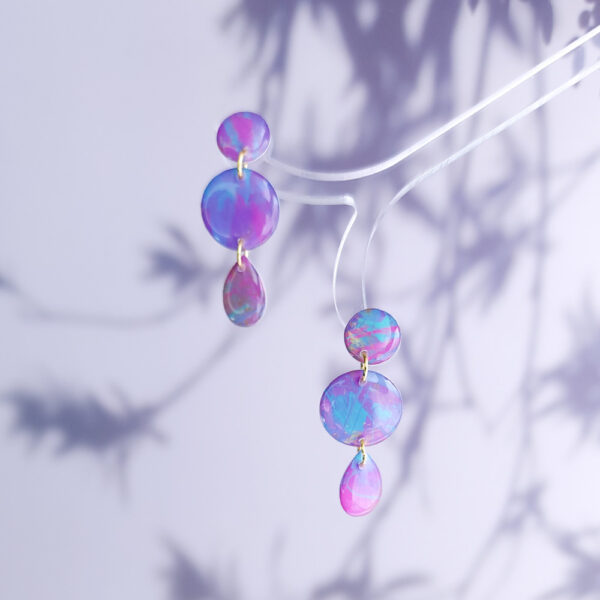 Brighten up your look with the hand-painted Pixie Pop Triple Drop earrings. These vibrant, colorful drops add playful charm to any outfit, perfect for standing out in style.