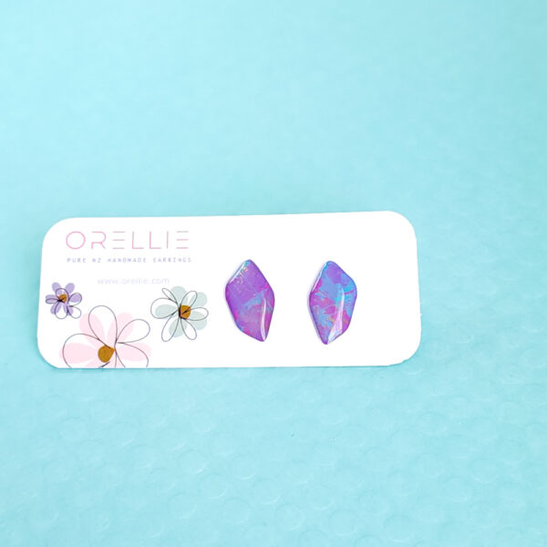 Add a pop of color with Pixie Drift earrings by Orellie. These hand-painted, diamond-shaped stud earrings bring a whimsical sparkle to your everyday or special occasion look.