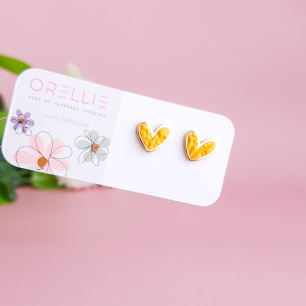 Add a touch of charm with the Heartbeat Collection from Orellie. These handcrafted heart-shaped earrings, available in vibrant colors, are the perfect accessory to showcase your unique style.