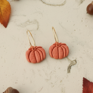 Celebrate the season with these handmade Halloween pumpkin earrings from Orellie. Lightweight, hypoallergenic, and available in vibrant fall colors – perfect for autumn vibes.